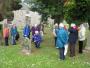 Liz Beevers shows the group an interesting headstone in Currie kirkyard